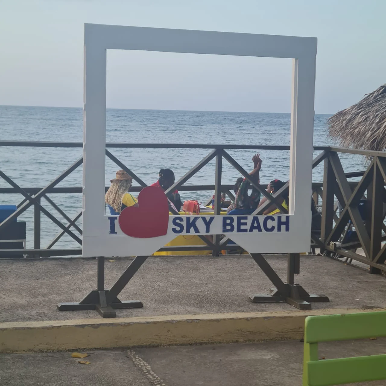 Sky Beach sign framing the sea